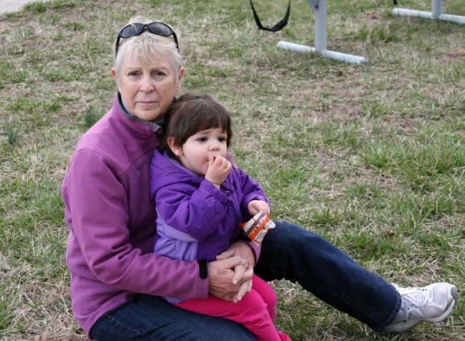 Grammy and Julia sitting on the grass